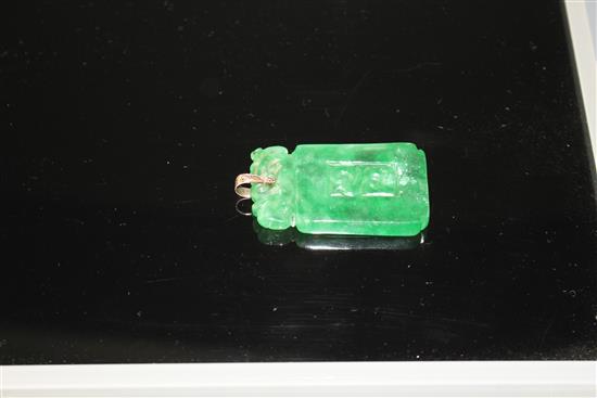 A simulated jade rectangular pendant with yellow metal mount (tests at 9ct gold), carved with scrolling motifs, 54mm,